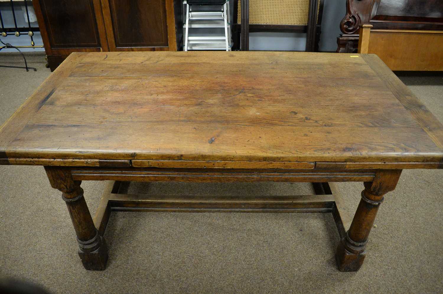 Lot 110 - Substantial 17th C style oak draw leaf dining table.