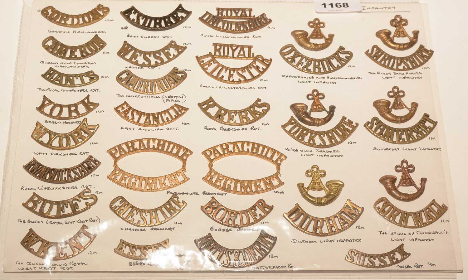 Lot 1168 - A collection of 27 single and 1 pair of metal shoulder titles.