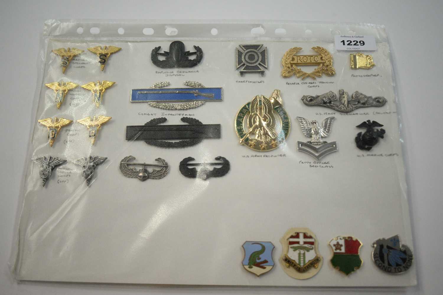 Lot 1229 - A collection of 24 American metal Insignia badges.