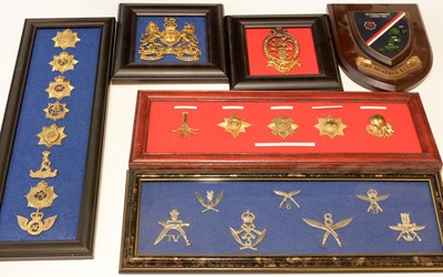 Lot 1254 - A collection of 8 framed cap badges and disbandment plaque.