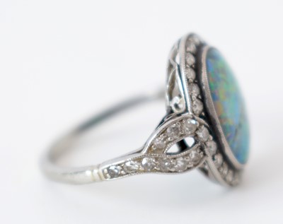Lot 54 - A black opal and diamond cluster ring.