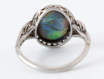 Lot 54 - A black opal and diamond cluster ring.