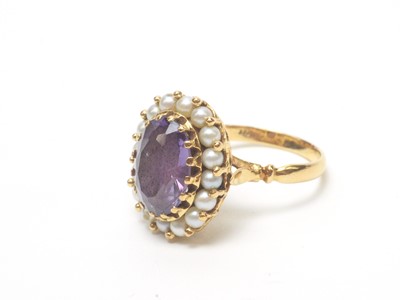 Lot 56 - A synthetic colour change sapphire and cultured pearl cluster ring.