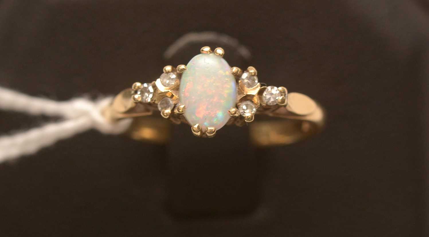 Lot 219 - Opal and diamond ring.