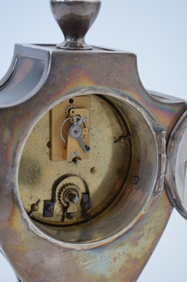 Lot 764 - An Edwardian silver and tortoiseshell mantel timepiece.