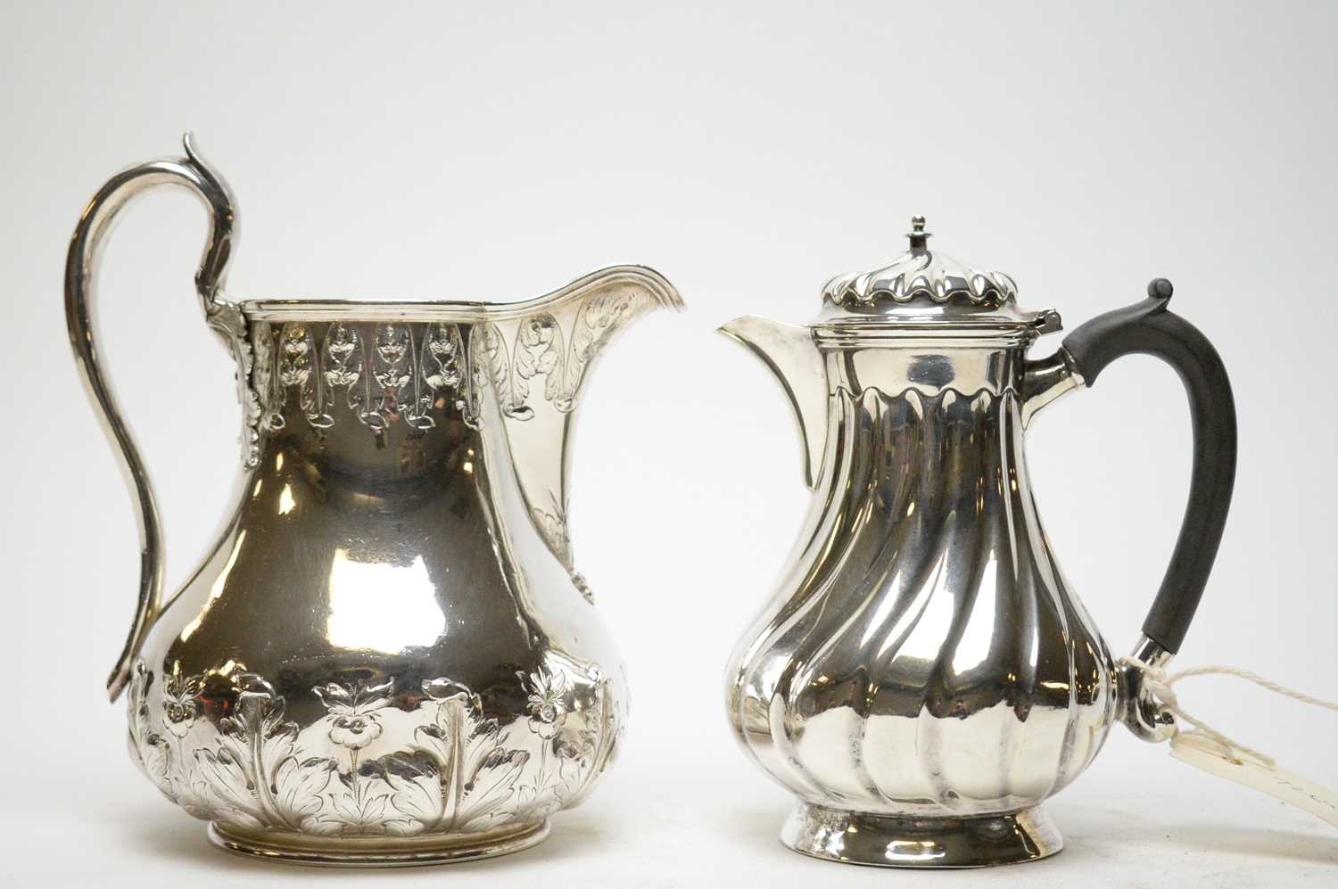 Lot 296 - Late Victorian silver hot water jug; and a Britannia metal water jug.