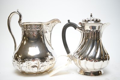 Lot 296 - Late Victorian silver hot water jug; and a Britannia metal water jug.