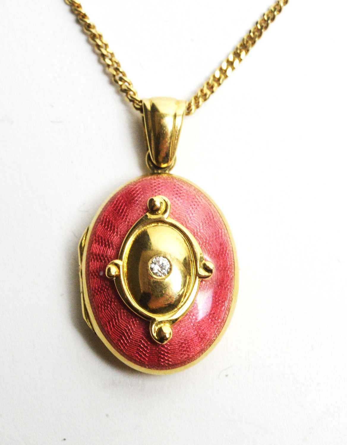 Lot 19 - An 18ct gold, enamel and diamond locket pendant