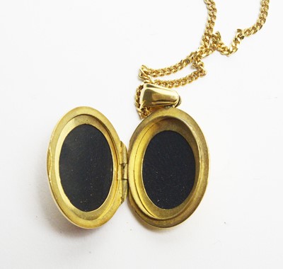 Lot 19 - An 18ct gold, enamel and diamond locket pendant
