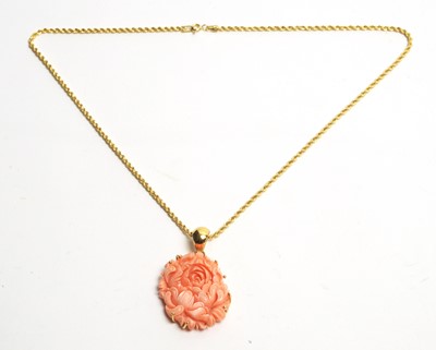 Lot 25 - A carved coral pendant on 18ct gold chain