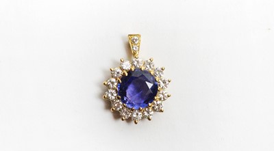 Lot 27 - A sapphire and diamond cluster pendant