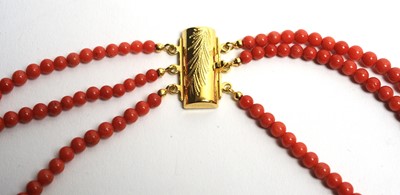Lot 30 - A three row coral bead necklace