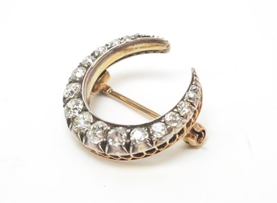 Lot 1 - A diamond crescent brooch.