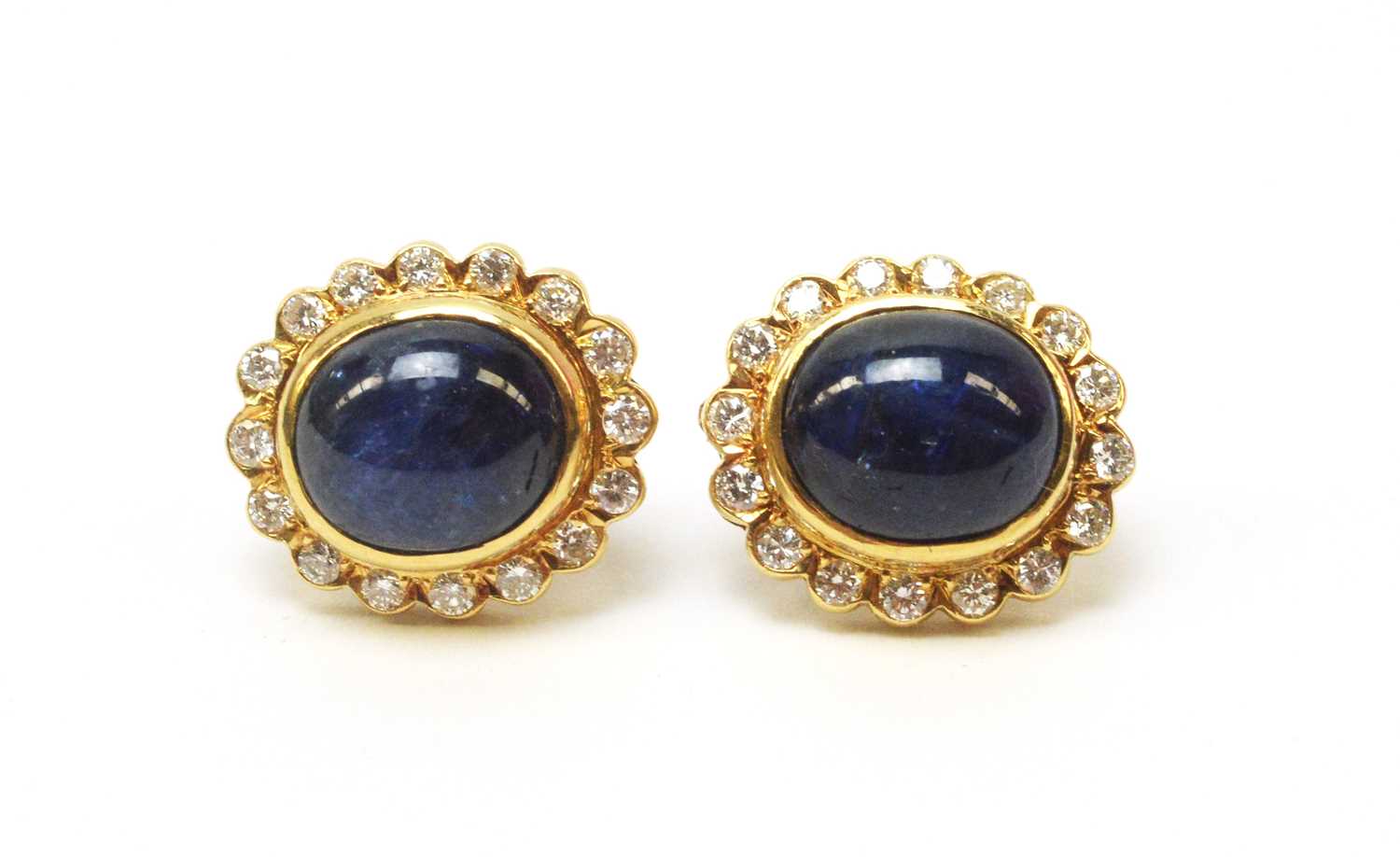 Lot 5 - A pair of sapphire and diamond cluster earrings.