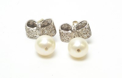 Lot 86 - A pair of diamond and cultured pearl drop earrings.