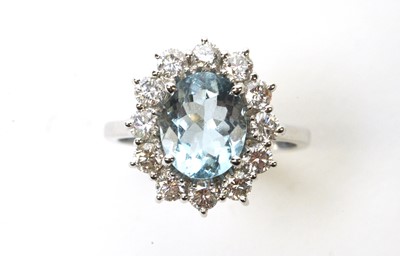 Lot 90 - An aquamarine and diamond cluster ring.