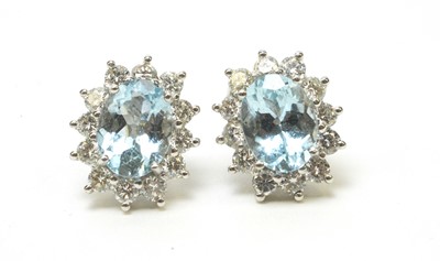 Lot 91 - A pair of aquamarine and diamond cluster earrings.