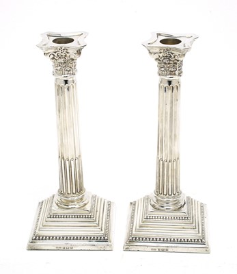 Lot 180 - A pair of Elizabeth II silver candlesticks.