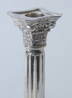 Lot 180 - A pair of Elizabeth II silver candlesticks.