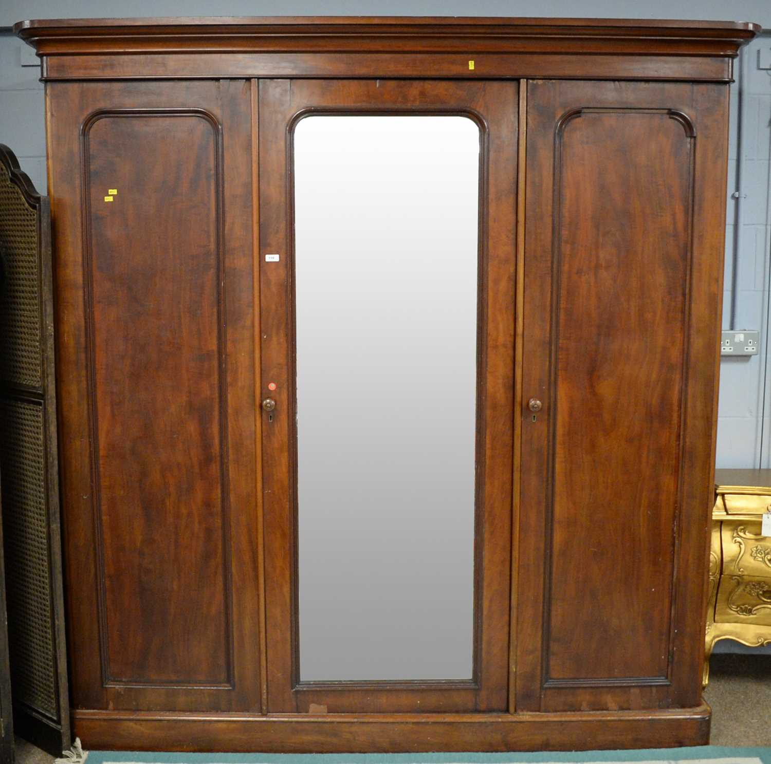 Lot 116 - A Victorian mahogany three-door wardrobe, the...
