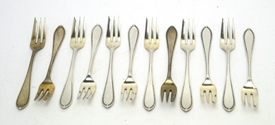 Lot 197 - A set of twelve German 800 standard silver cake forks.