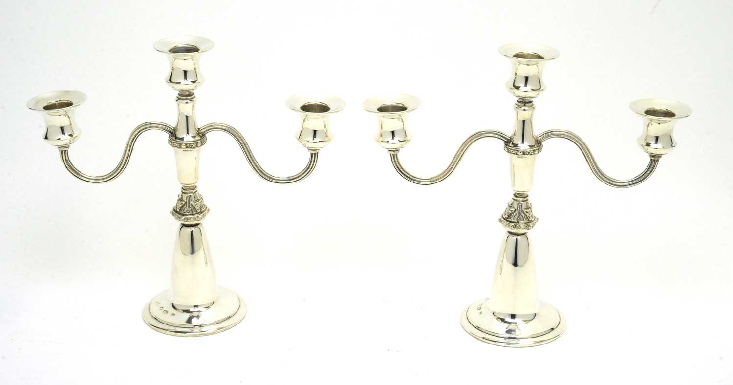Lot 192 - A pair of silver candelabra