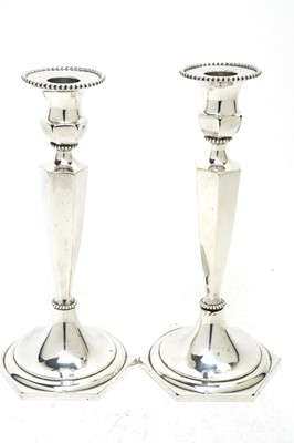Lot 178 - A pair of DLI interest silver candlesticks