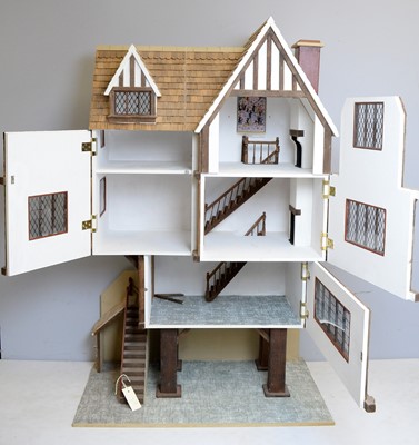 Lot 961 - A three-storey Tudor-style doll's house.