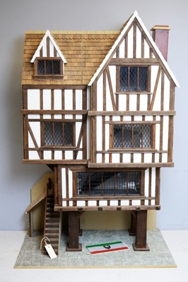 Lot 961 - A three-storey Tudor-style doll's house.