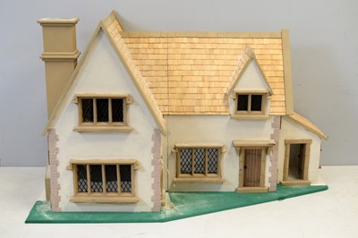 Lot 965 - A two-storey country mansion style doll's house.
