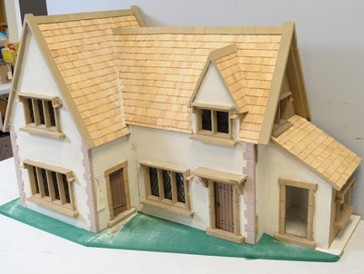 Lot 965 - A two-storey country mansion style doll's house.