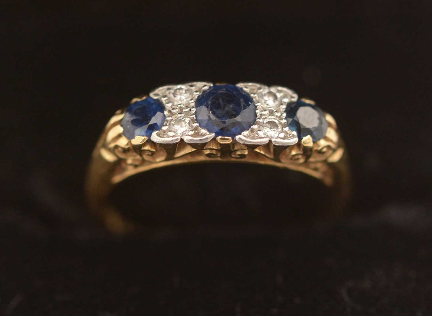 Lot 310 - Sapphire and diamond ring.