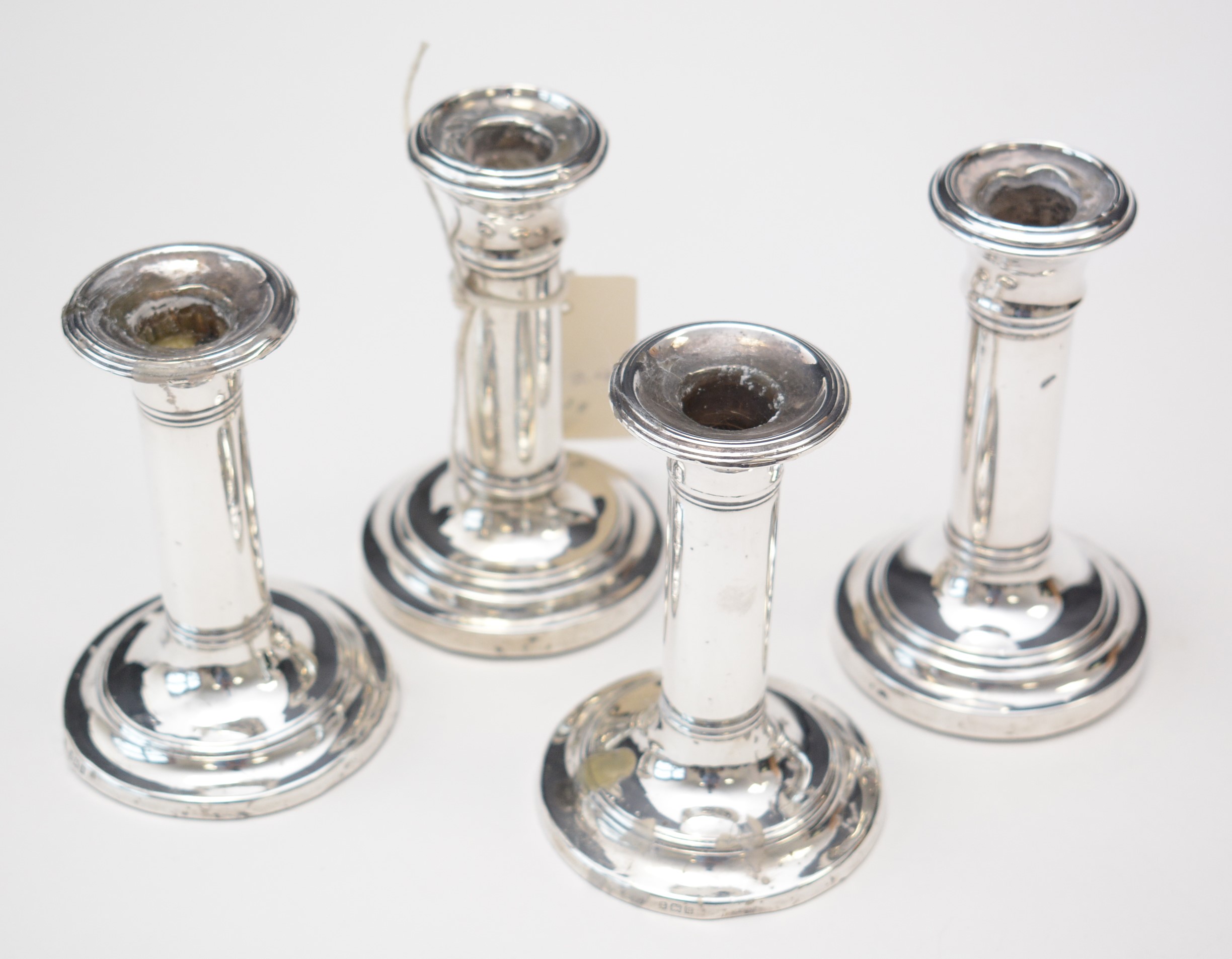 Lot 197 Set of four silver candlesticks.