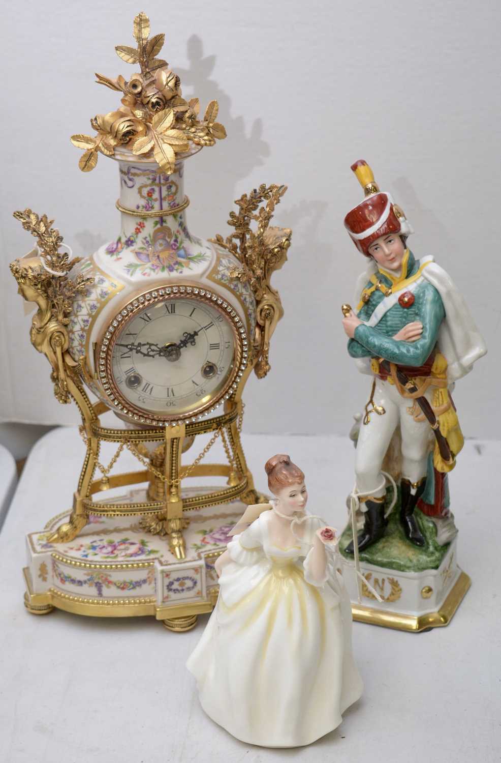 Lot 299 - A clock and two figurines.