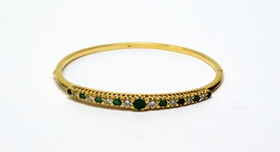 Lot 33 - An emerald and diamond bangle