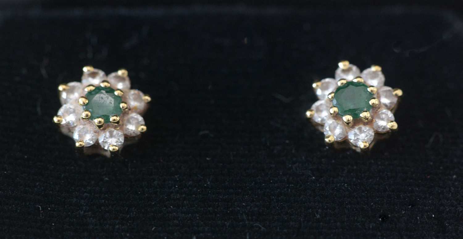 Lot 289 - A pair of emerald and diamond cluster earrings.