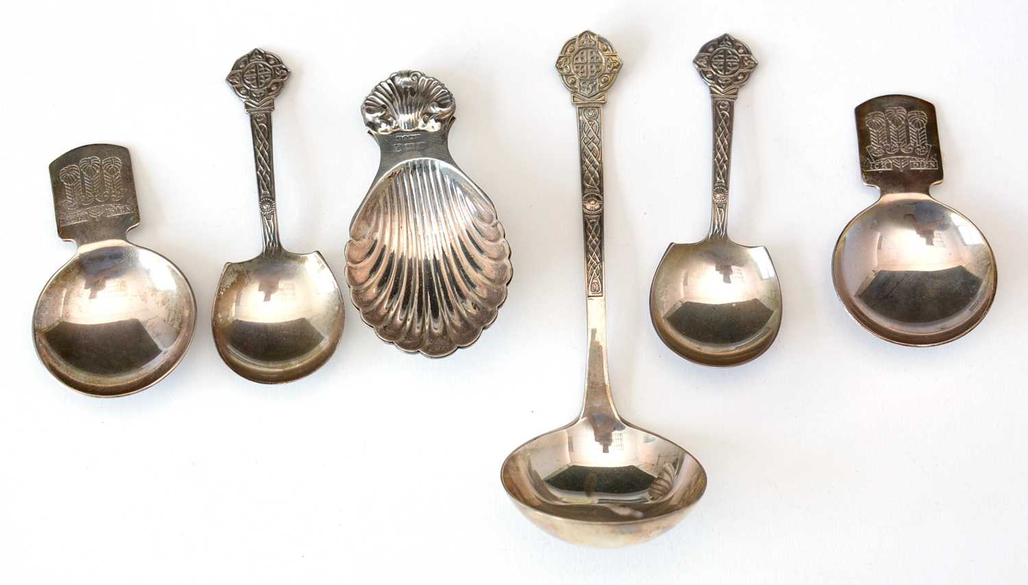 Lot 250 - Caddy spoons, and a sauce ladle.