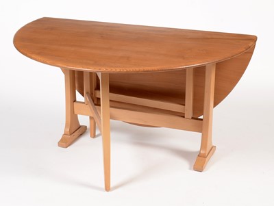 Lot 853 - Ercol: an elm and beechwood drop leaf dining table.