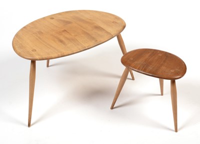 Lot 854 - Ercol: two from a set of three beech and elm 'Pebble' tables.