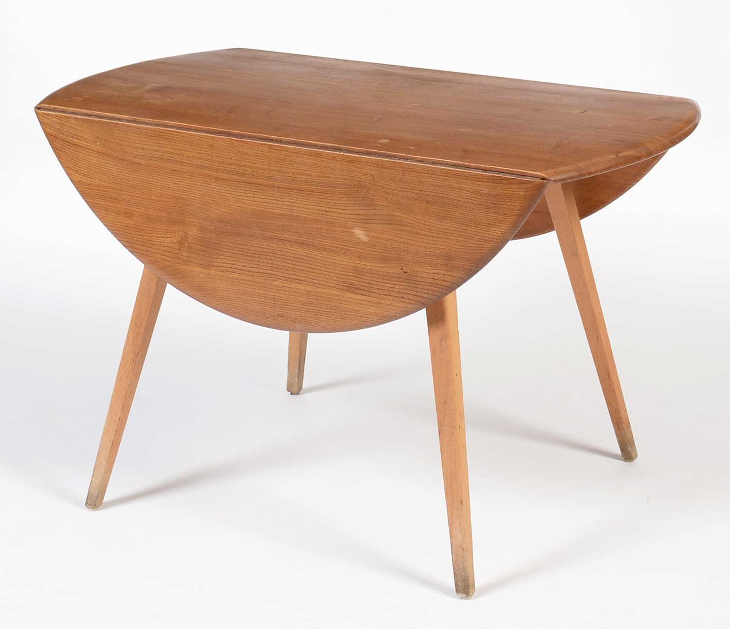 Lot 855 - Ercol: an elm and beech wood drop leaf dining table.