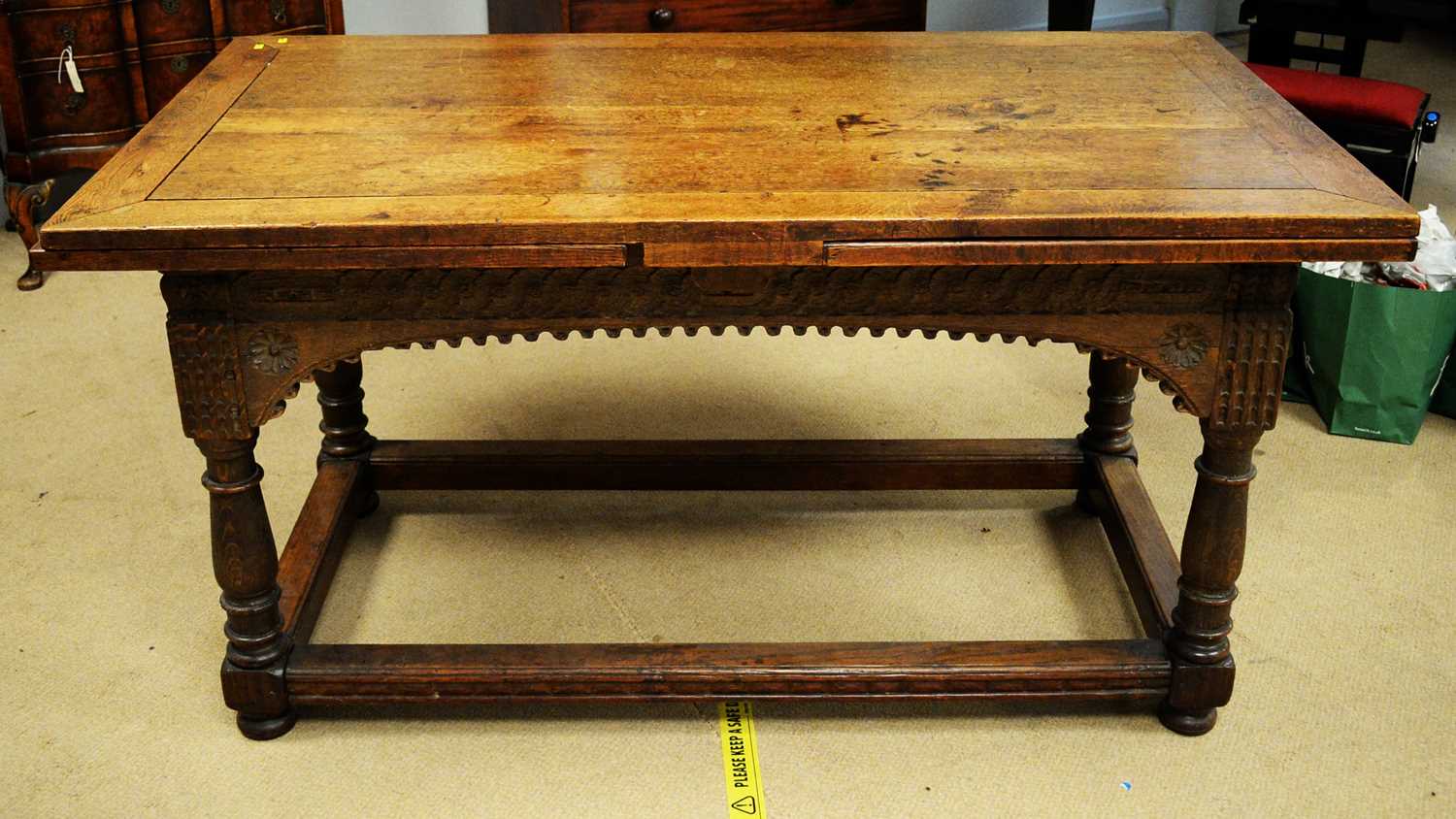 Lot 117 - An early 20th Century oak drawers leaf trestle table