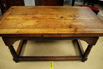 Lot 117 - An early 20th Century oak drawers leaf trestle table