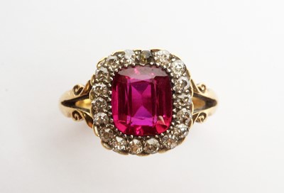 Lot 27 - A yellow metal, diamond, and synthetic ruby ring.