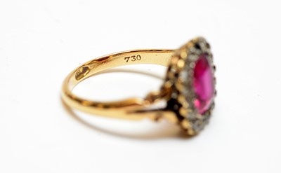 Lot 27 - A yellow metal, diamond, and synthetic ruby ring.