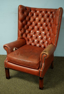 Lot 20 - 20th C leather upholstered wing-back armchair.