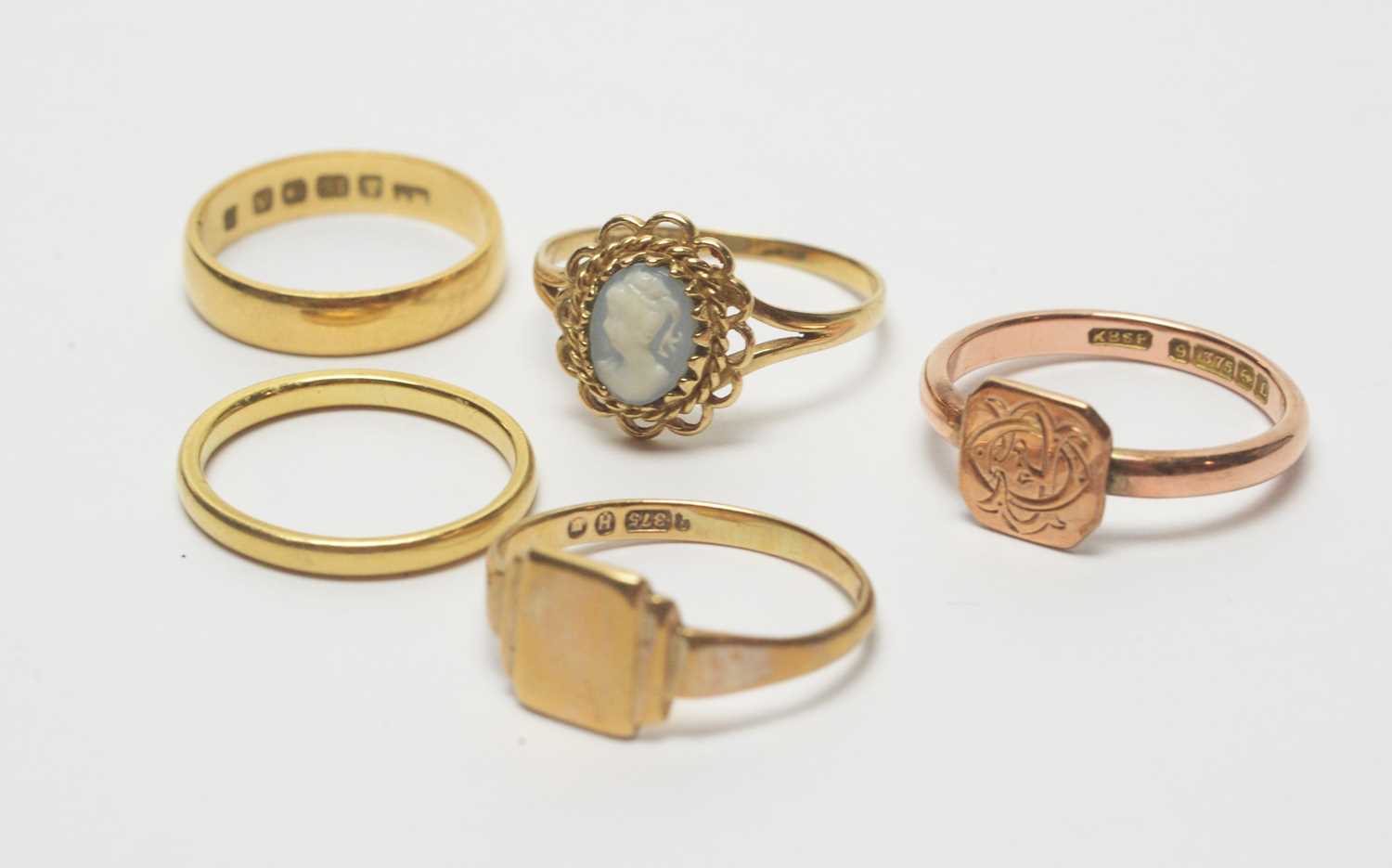Lot 193 - Two gold wedding bands, a cameo ring and two signet rings.