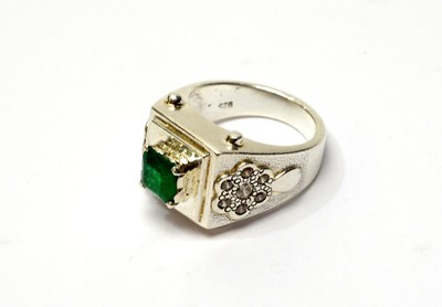 Lot 48 - An emerald and white stone ring