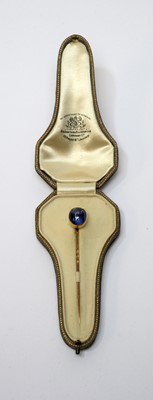 Lot 10 - A sapphire cabochon tie pin