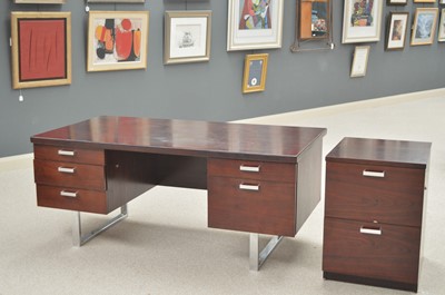 Lot 886 - Trevor Chinn for Gordon Russell: a rosewood and chromed metal pedestal desk and filing cupboard.