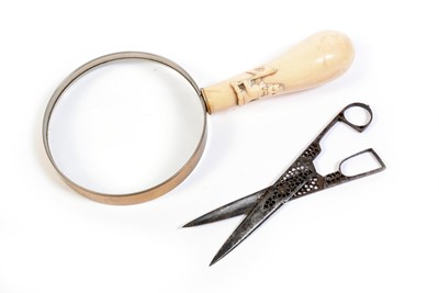 Lot 596 - A pair of steel scissors; and a magnifying glass